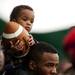 One-year-old and Ypsilanti resident Ashton Ward sits on his dad John's shoulders during the EMU spring practice on Sunday, April 14. AnnArbor.com I Daniel Brenner